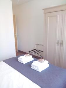 two towels sitting on a bed in a room at BOKATEA in Cambo-les-Bains