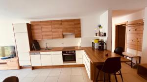 a kitchen with white cabinets and a counter with a sink at Appartement Nadia in Bressanone