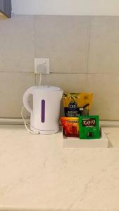 a coffee pot and some snacks on a counter at 3 Bed Backpack Edusphere Suite in Cyberjaya