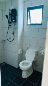 a bathroom with a toilet and a window at 3 Bed Backpack Edusphere Suite in Cyberjaya