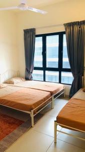 a bedroom with two beds and a large window at 3 Bed Backpack Edusphere Suite in Cyberjaya