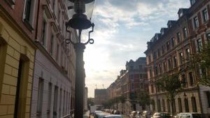 a street with cars parked on a street with buildings at Phoenix in Chemnitz