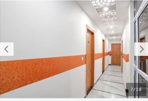 a corridor of an office building with a hallway at Moms Hostel in Agra
