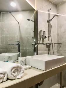 a bathroom with a white sink and a mirror at New Gudauri Panorama View Loft II in Gudauri
