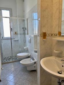 a bathroom with a shower and a toilet and a sink at Residence Rimini Relax in Rimini