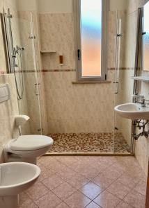 a bathroom with two toilets and a shower at Residence Rimini Relax in Rimini