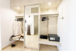 a dressing room with a mirror and a closet at AK Suites in Imerovigli