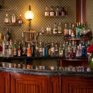 a bar filled with lots of bottles of alcohol at Hotel Mecenate Palace in Rome