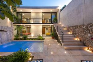 a house with a swimming pool and stairs at Meriblau Hotel Boutique in Mérida