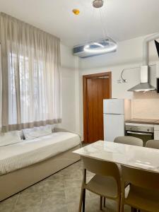 a bedroom with a bed and a table with chairs at Residence Rimini Relax in Rimini