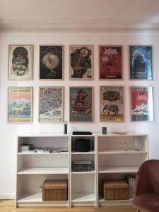 a living room with a wall with posters at Charme et confort en plein centre historique in Nantes