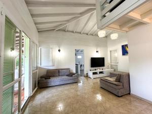 TV a/nebo společenská místnost v ubytování Maison à 3 min à pied de la plage