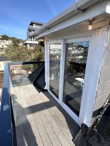 a porch of a house with sliding glass doors at Luxury Detached House in Torquay Marina in Torquay