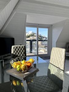 a bowl of fruit on a glass table in a room at Luxury Detached House in Torquay Marina in Torquay