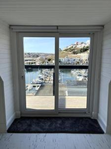 a window in a room with a view of a marina at Luxury Detached House in Torquay Marina in Torquay