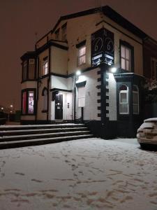 a building with snow on the ground in front of it at Kop View in Liverpool