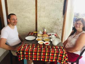 un hombre y una mujer sentados en una mesa con comida en Nethmi Homestay & Restaurant en Tangalle