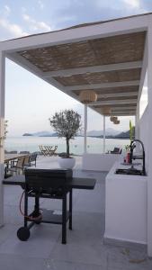 a patio with a table with a tree on it at Sea Breeze Villa in Fujairah