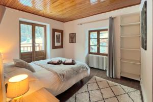 a bedroom with a bed and a wooden ceiling at Chalet Le Loup - charming Tignes ski chalet in a superb location in Tignes