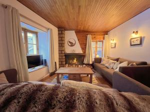 a living room with a couch and a table at Chalet Le Loup - charming Tignes ski chalet in a superb location in Tignes