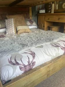 a bed in a room with a wooden frame at Bridie Rose - hot tub extra charge in Kington