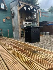 a backyard deck with an outdoor kitchen in a house at Bridie Rose - hot tub extra charge in Kington