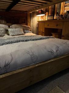 a bedroom with a bed with a wooden frame at Bridie Rose - hot tub extra charge in Kington