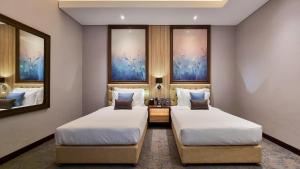 Una cama o camas en una habitación de Millennium Place Doha
