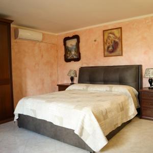 a bedroom with a large bed and two night stands at Appartamento La Vista in Budoni