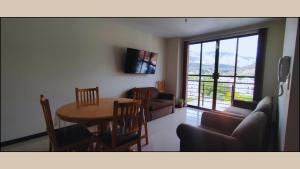 a living room with a table and a couch at Departamento Vistas Ambar - 1 Dormitorio in Cochabamba