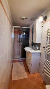 a bathroom with a sink and a shower at Appartamento La Vista in Budoni +13 photos