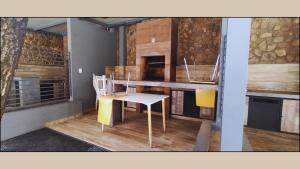 a kitchen with a table and a chair in a room at Departamento Vistas Ambar - 1 Dormitorio in Cochabamba