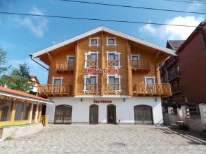 a large wooden building with a sign on it at Altair Hotel in Bukovel