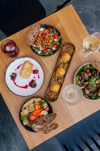 a wooden table with plates of food on it at Slow Tatry Boutique Resort in Zakopane