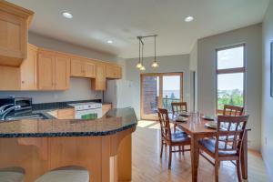 a kitchen and dining room with a table and chairs at Tofte Tranquility Lakefront Townhome with Balcony! in Tofte