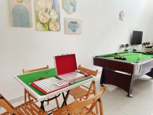 a desk with a laptop computer and a pool table at Bandar Putra 16pax Ktv Snooker BBQ /IOI Mall /JPO/Aeon/Senai Airport in Kulai