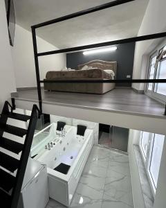 a loft bed with a sink and a bed on top at LUIGI LUXURY SUITE in Naples