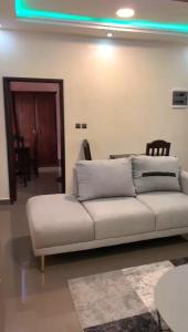 a living room with a white couch and a table at CISFOP in Abomey-Calavi