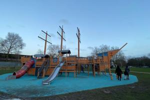 a playground in a park with a slide at MODERN 1 Bedroom Ground Floor Flat in London