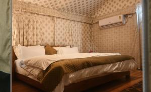 a bedroom with a bed in a room at Bundeli Resorts in Rājgarh