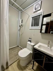 a bathroom with a white toilet and a sink at H&T PJ Gasing - Cabin Studio - Netflix & Free Parking in Petaling Jaya