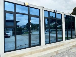 a group of glass windows on a building at H&T PJ Gasing - Cabin Studio - Netflix & Free Parking in Petaling Jaya