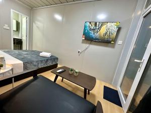 a small room with a bed and a table at H&T PJ Gasing - Cabin Studio - Netflix & Free Parking in Petaling Jaya