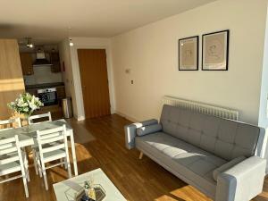 a living room with a couch and a table at Luxury 1 Bedroom Apartment - City Centre - Balcony - Near O2 Academy in Birmingham