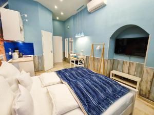 a bedroom with a white bed and a blue wall at King Apartment in Budapest