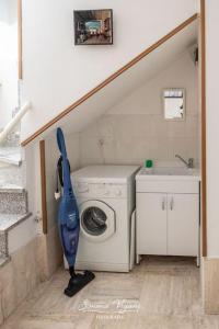 a house with a washing machine and a staircase at Letizia Lake House - Lovere in Lovere