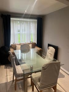 a dining room with a glass table and chairs at Stylish Darlington Townhouse Near A1 A66 & A19 Breakfast in Darlington
