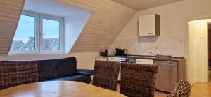 a living room with a table and a kitchen at Apartments Leverkusen in Leverkusen