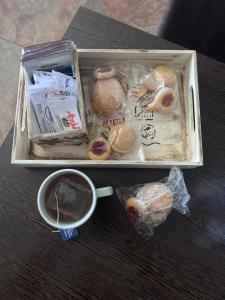 a box of food and a cup of coffee on a table at Suite in Tres Arroyos