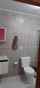 a bathroom with a toilet and a towel on the wall at Sitio Hoffmann in Pomerode